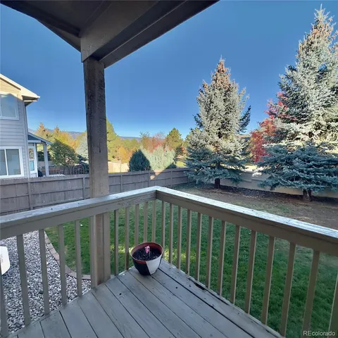 a view of balcony with wooden floor and fence
