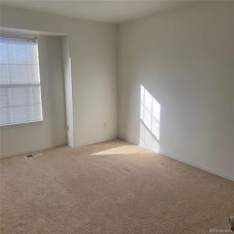 an empty room with windows and closet