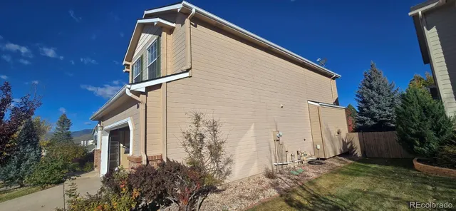 a backyard of a house with plants and trees