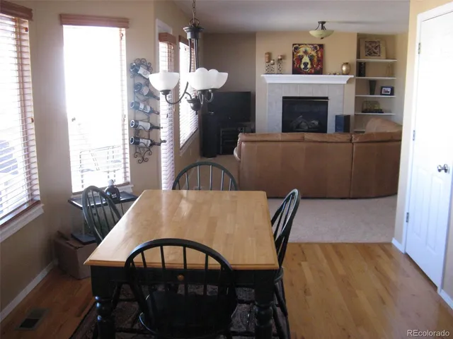 a view of a dining room with furniture and a fireplace