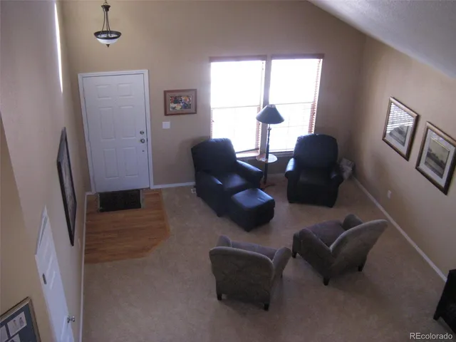 a living room with furniture rug and a window