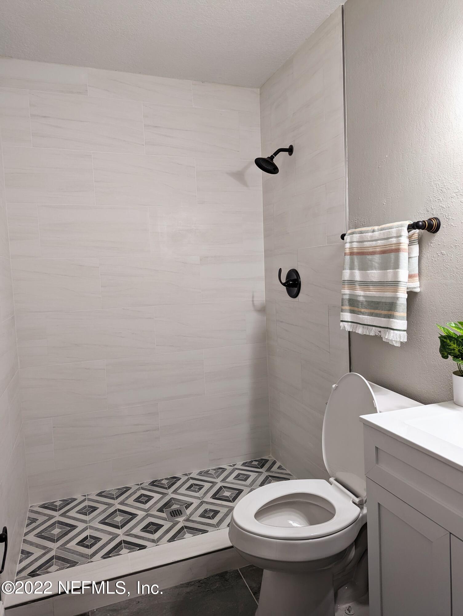 12855 Attrill Road Jacksonville, FL 32258 - Photo 11 of 16 a bathroom with a sink a toilet and shower