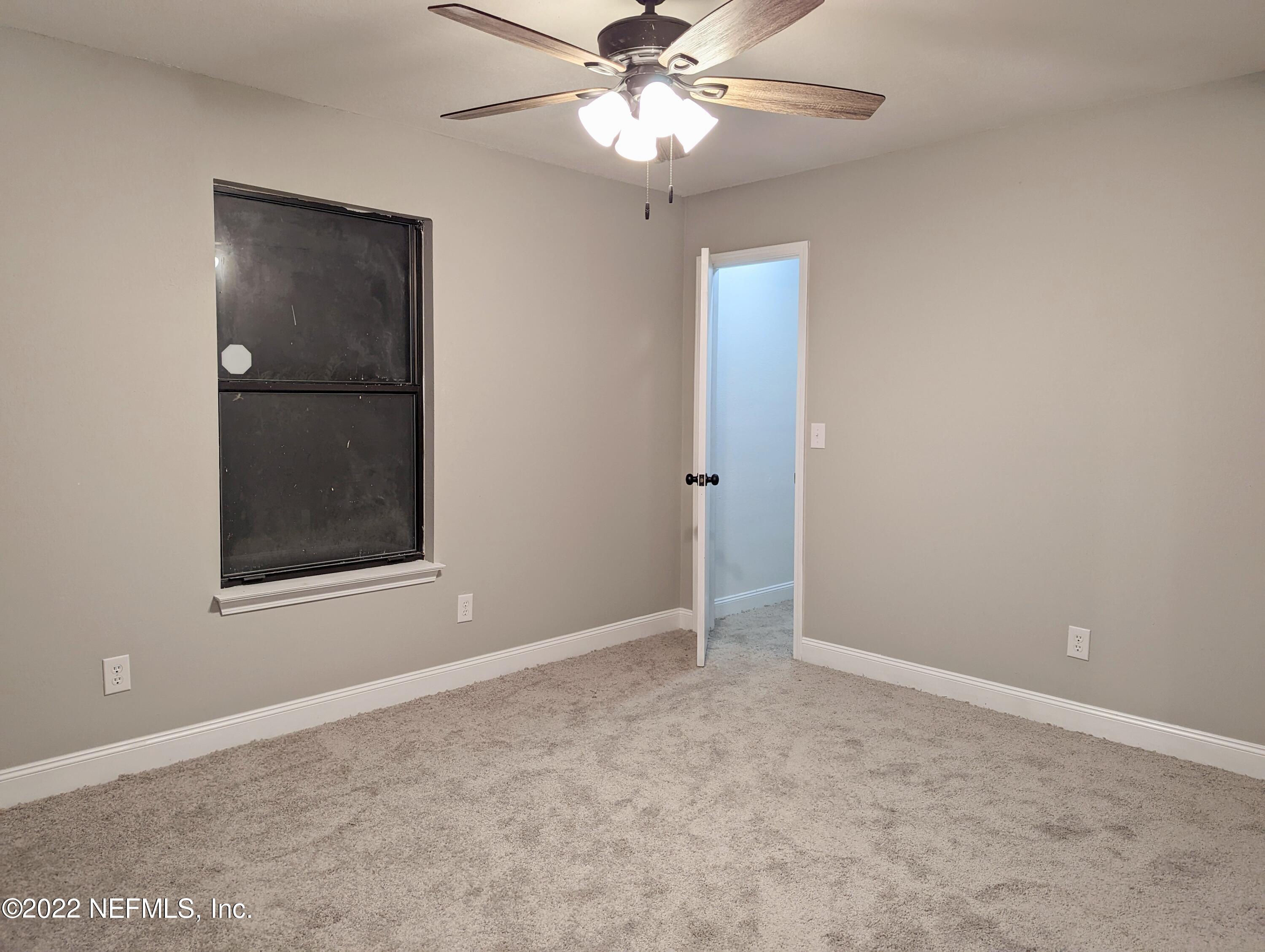 12855 Attrill Road Jacksonville, FL 32258 - Photo 12 of 16 an empty room with fan and windows