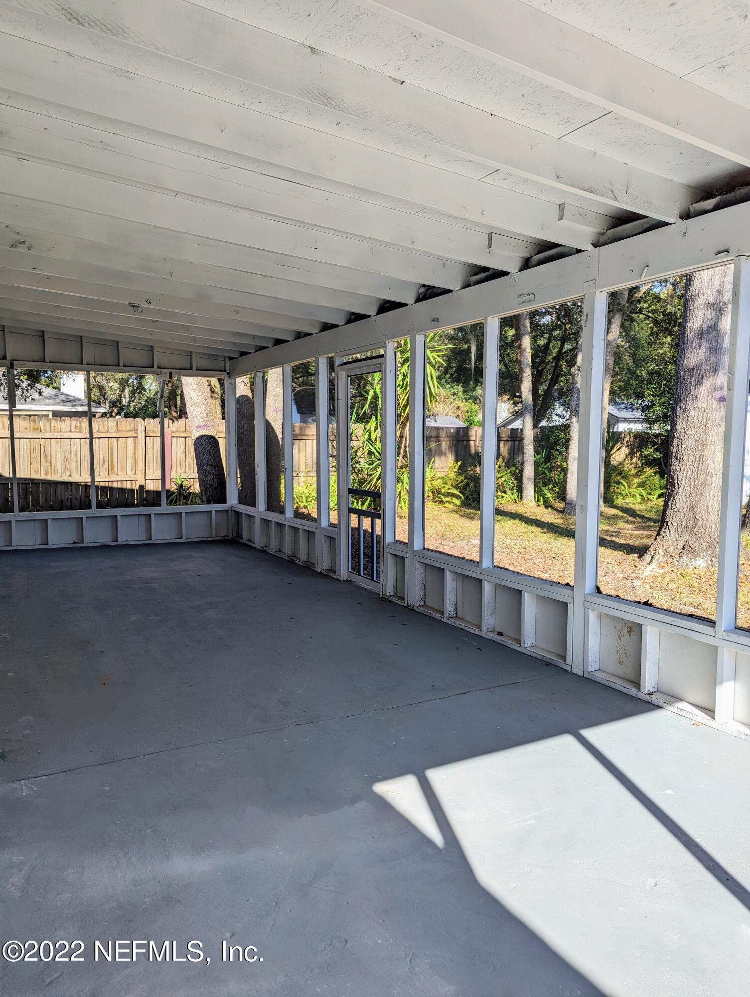 12855 Attrill Road Jacksonville, FL 32258 - Photo 13 of 16 a view of an empty room with a floor to ceiling window and an outdoor view