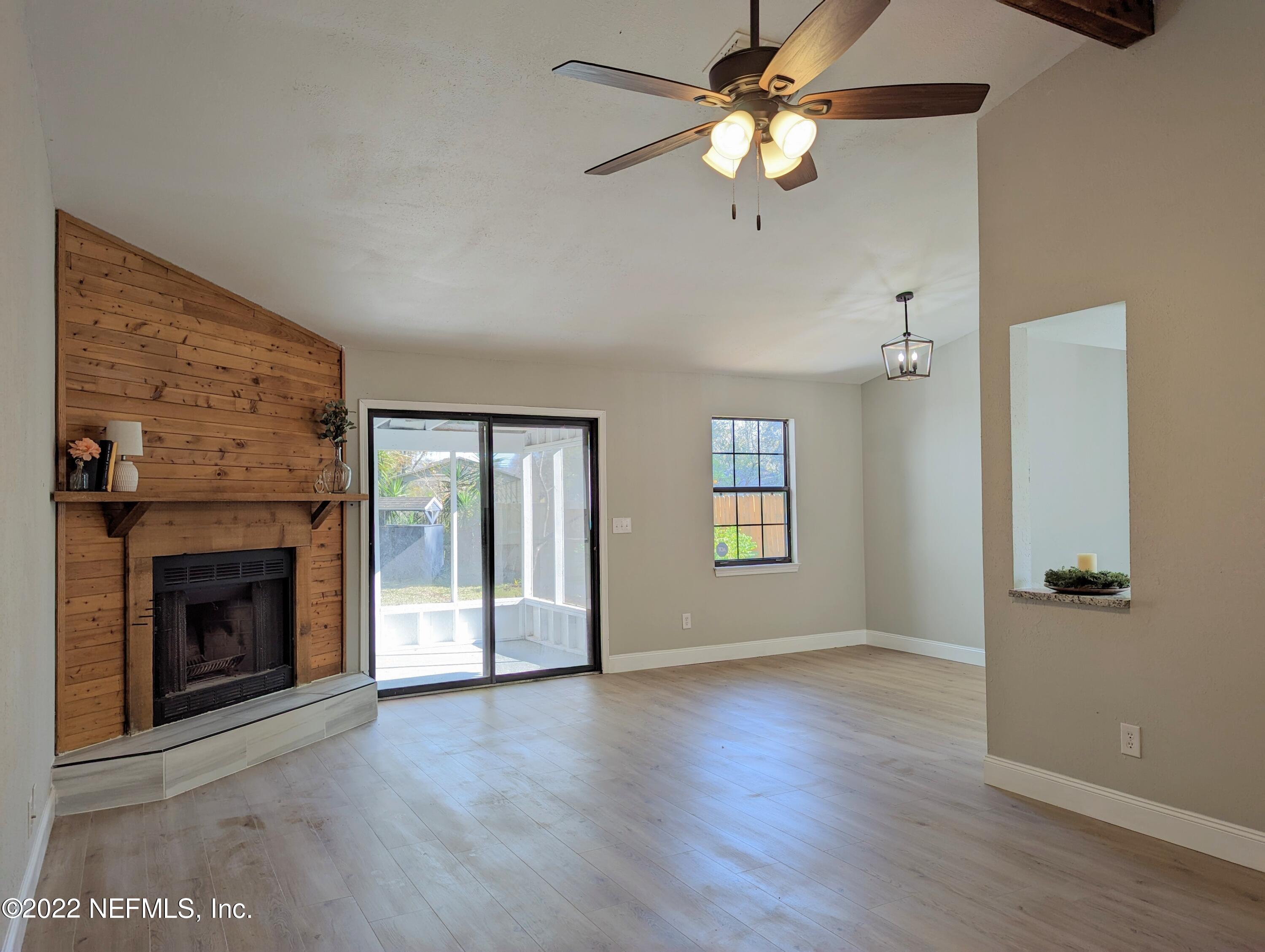 12855 Attrill Road Jacksonville, FL 32258 - Photo 4 of 16 an empty room with windows and fireplace