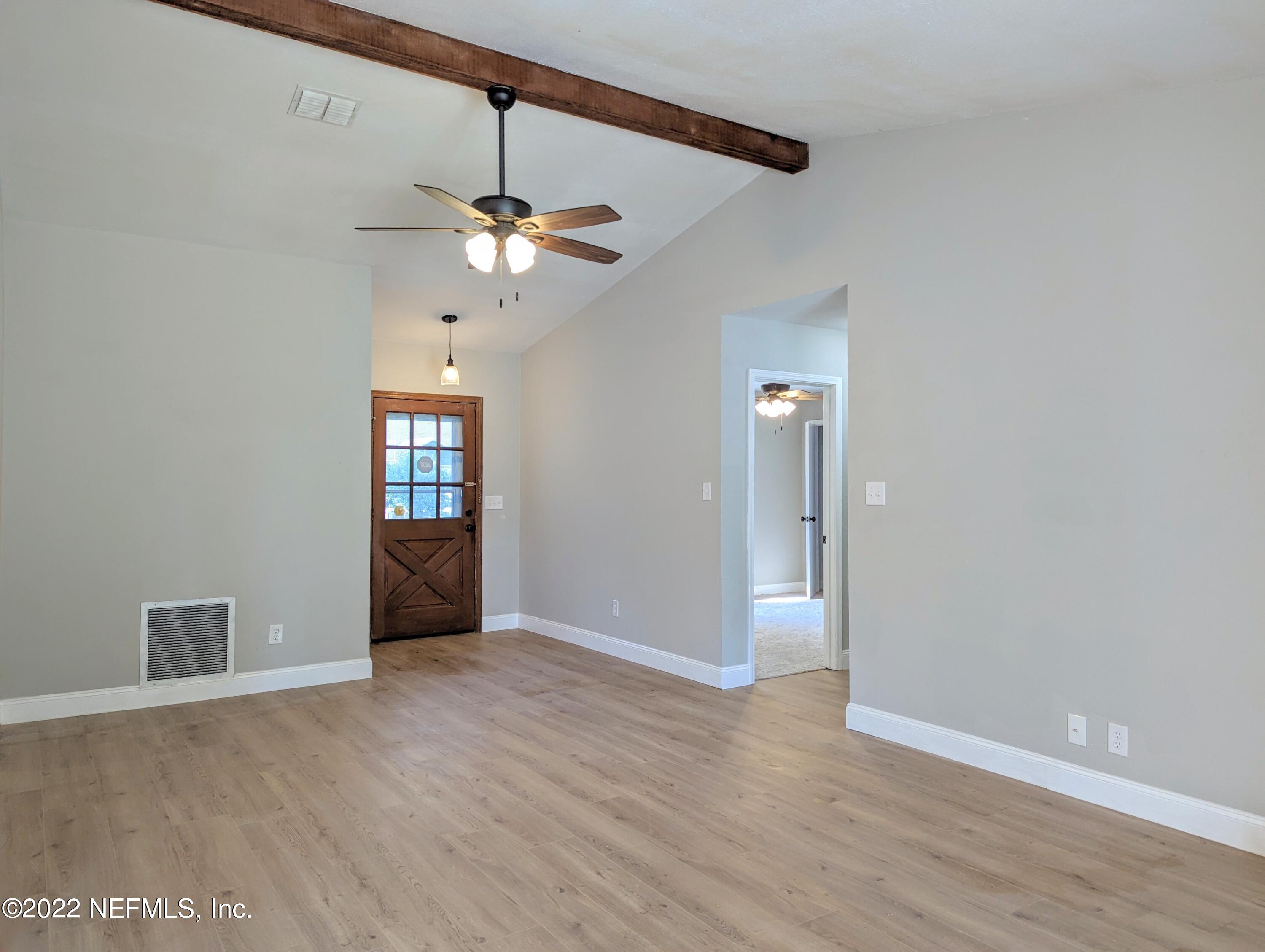 12855 Attrill Road Jacksonville, FL 32258 - Photo 7 of 16 a view of an empty room with window and wooden floor
