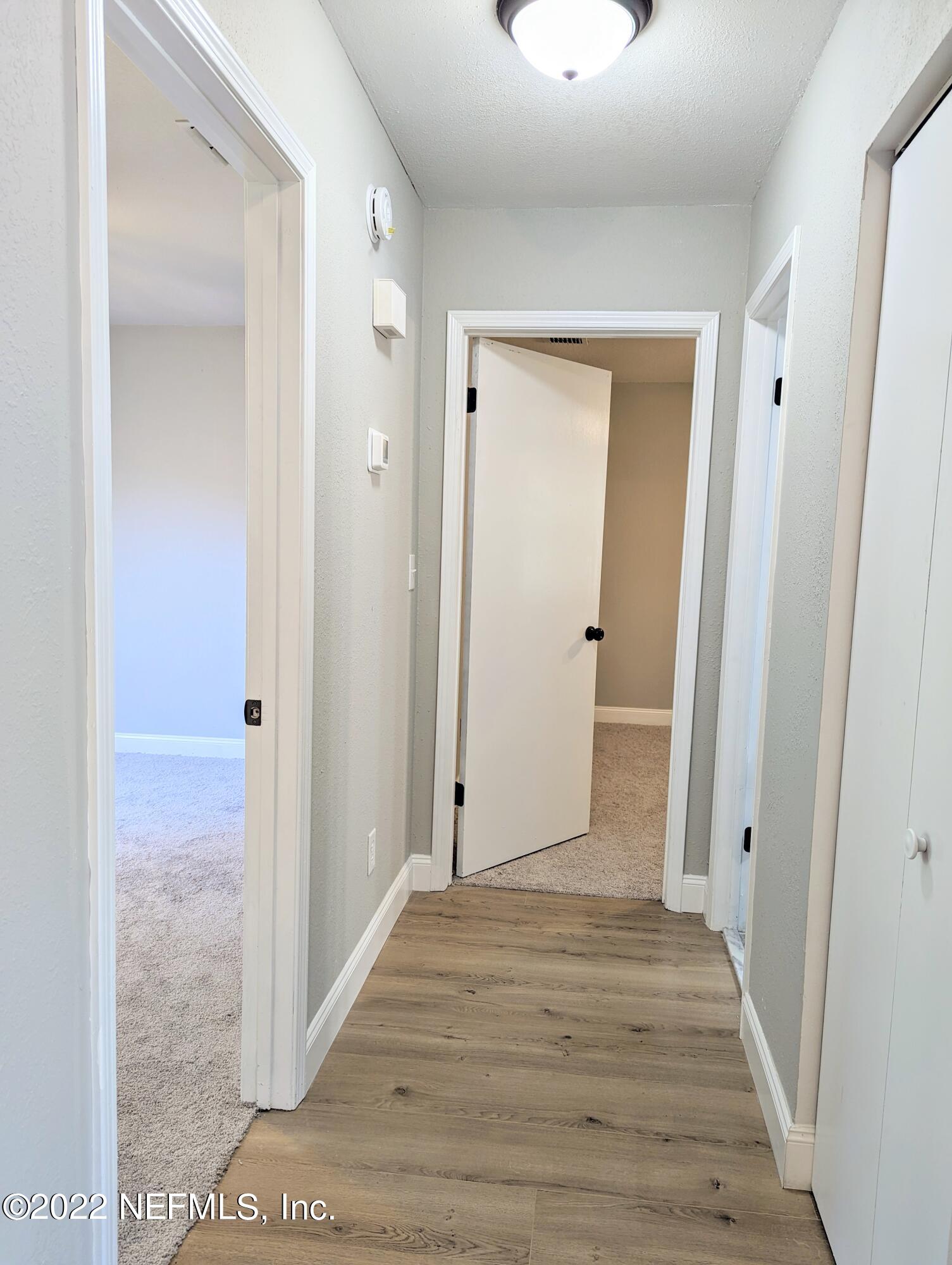 12855 Attrill Road Jacksonville, FL 32258 - Photo 8 of 16 a view of a hallway with wooden floor