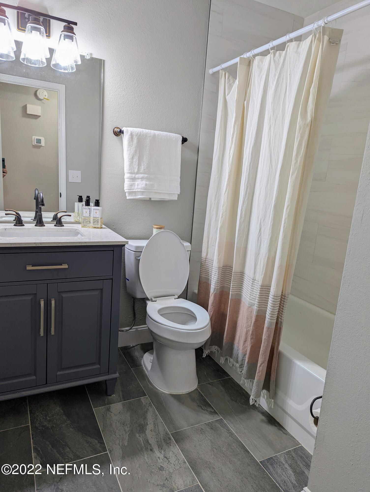 12855 Attrill Road Jacksonville, FL 32258 - Photo 9 of 16 a bathroom with a toilet a sink and a mirror