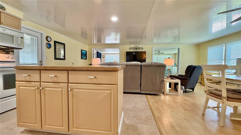 716 Blackburn Boulevard North Port, FL 34287 - Photo 11 of 48 a living room with furniture a flat screen tv and kitchen view