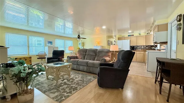 a living room with furniture wooden floor and a flat screen tv