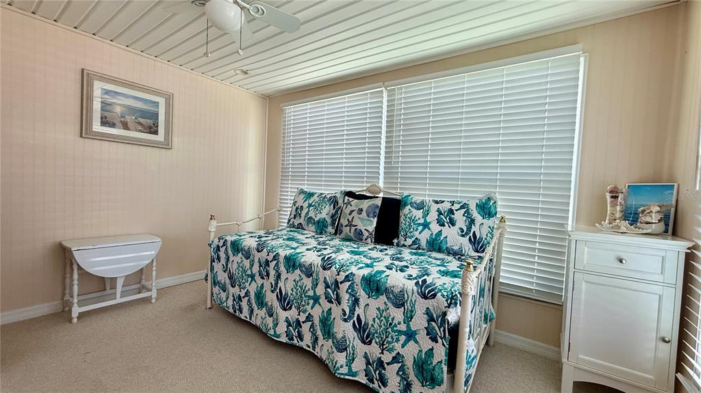 716 Blackburn Boulevard North Port, FL 34287 - Photo 19 of 48 a bed sitting in a bedroom next to a window and a chair