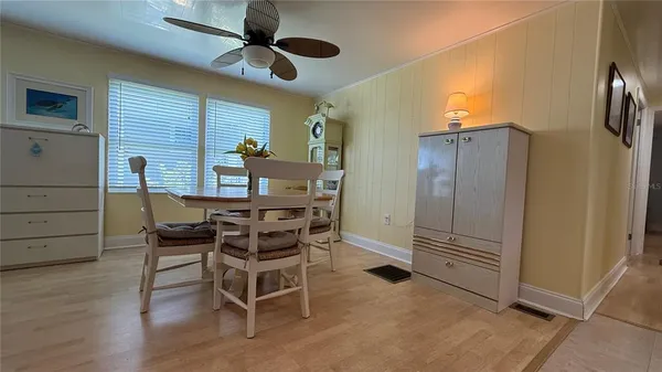 a view of a dining room with furniture and wooden floor