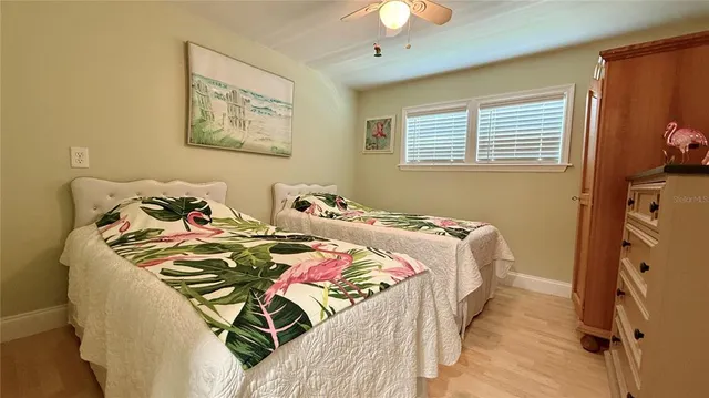 a bedroom with bed and a chandelier