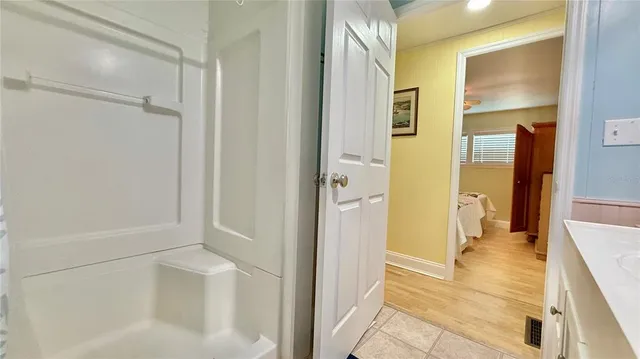 a view of a bathroom with a tub and shower