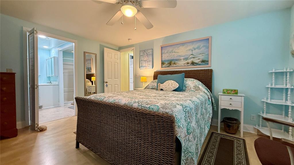 716 Blackburn Boulevard North Port, FL 34287 - Photo 34 of 48 a bedroom with a bed and a chandelier