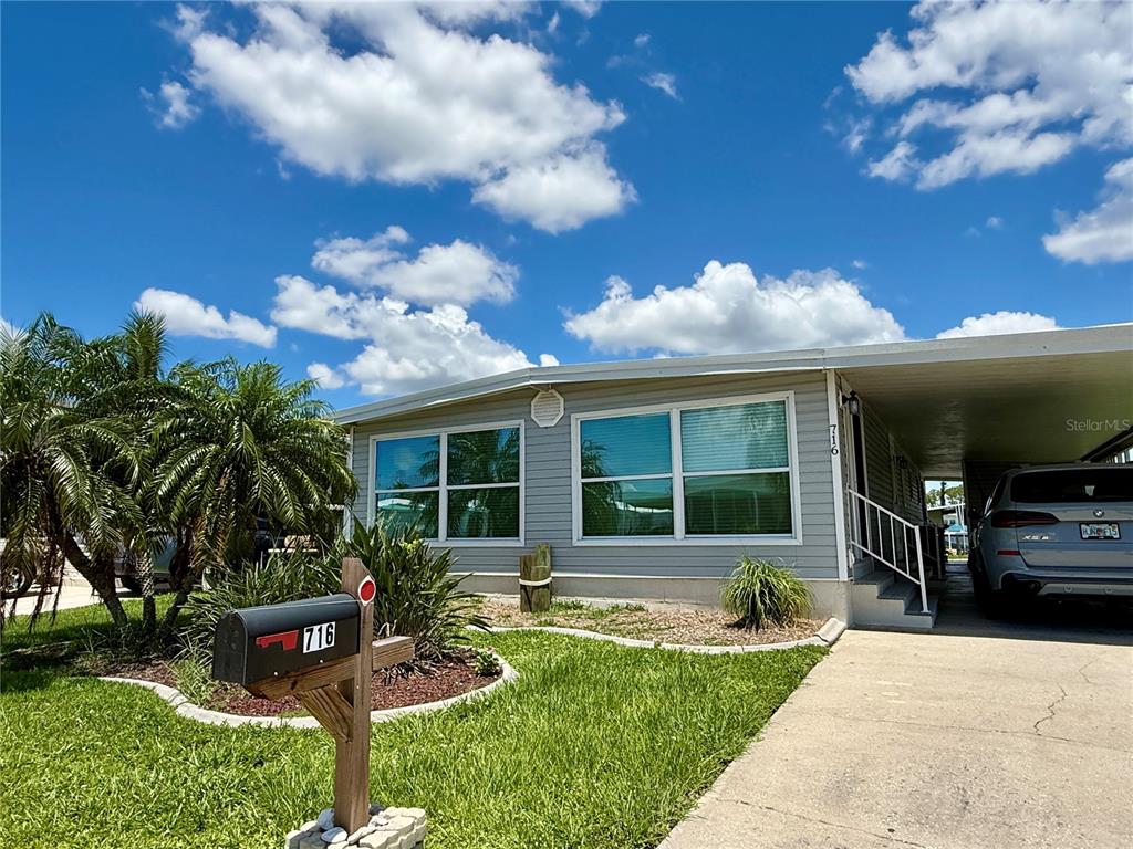 716 Blackburn Boulevard North Port, FL 34287 - Photo 4 of 48 a front view of a house with garden and patio