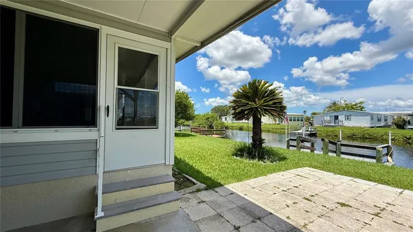 a front view of a house with a yard and lake view