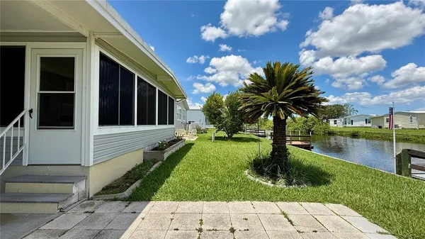 a view of a house with backyard porch and sitting area