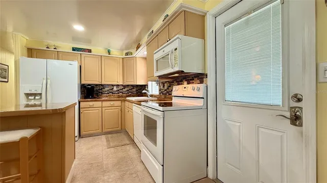 a kitchen with a refrigerator stove and sink