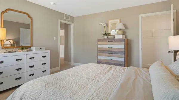 a bedroom with a bed and a dresser