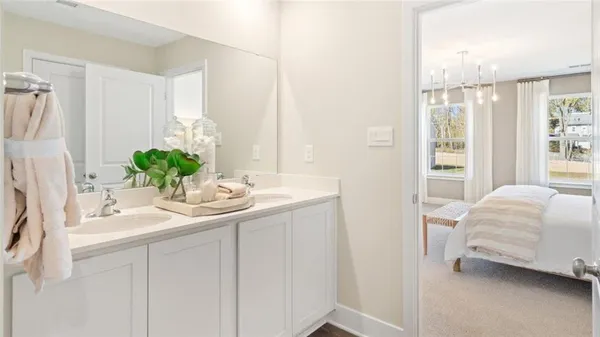 a en suite bathroom with a double sink and mirror