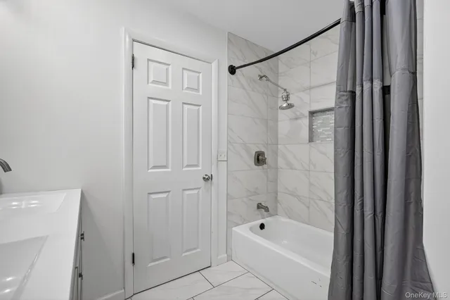 a bathroom with a shower a bathtub and a shower