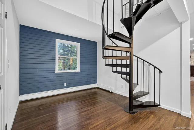 a view of an entryway with wooden floor and door
