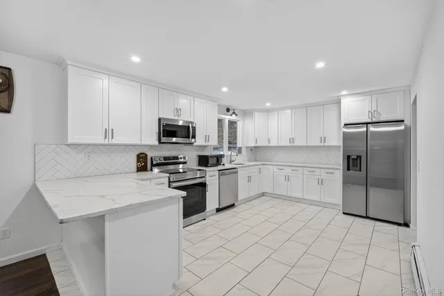 a kitchen with cabinets stainless steel appliances and a counter space