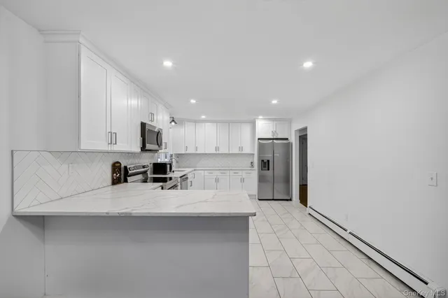 a kitchen with stainless steel appliances a refrigerator sink and counter top
