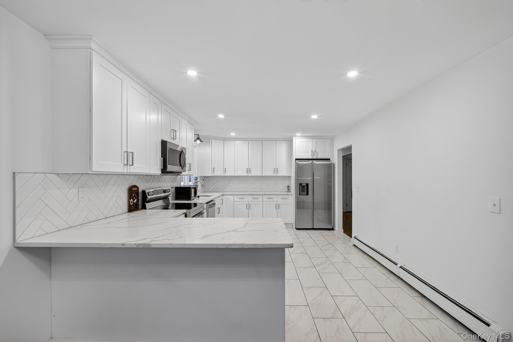 51 Sterling Road Carmel, NY 10512 - Photo 10 of 38 a kitchen with stainless steel appliances a refrigerator sink and counter top