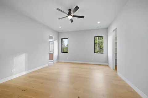 a view of a livingroom with a ceiling fan and window