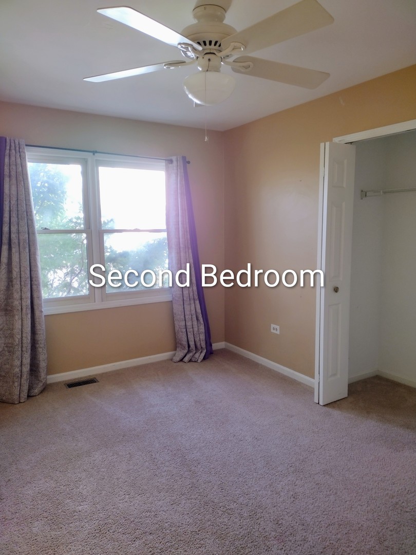 267 Silverado Street Bolingbrook, IL 60490 - Photo 11 of 16 an empty room with a window and a ceiling fan
