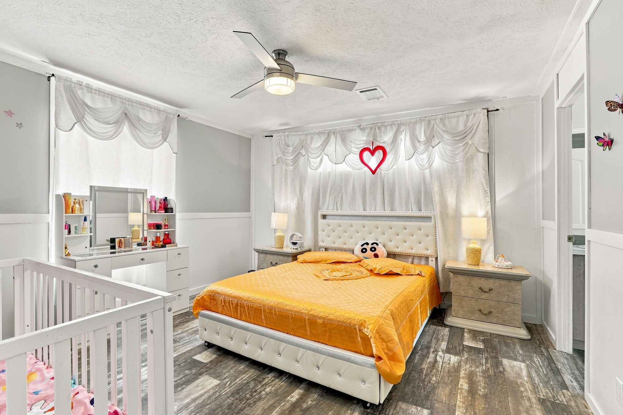 1039 Trailside Elgin, TX 78621 - Photo 11 of 24 Rustic wood-look flooring and classic wainscoting details anchor this inviting bedroom space.