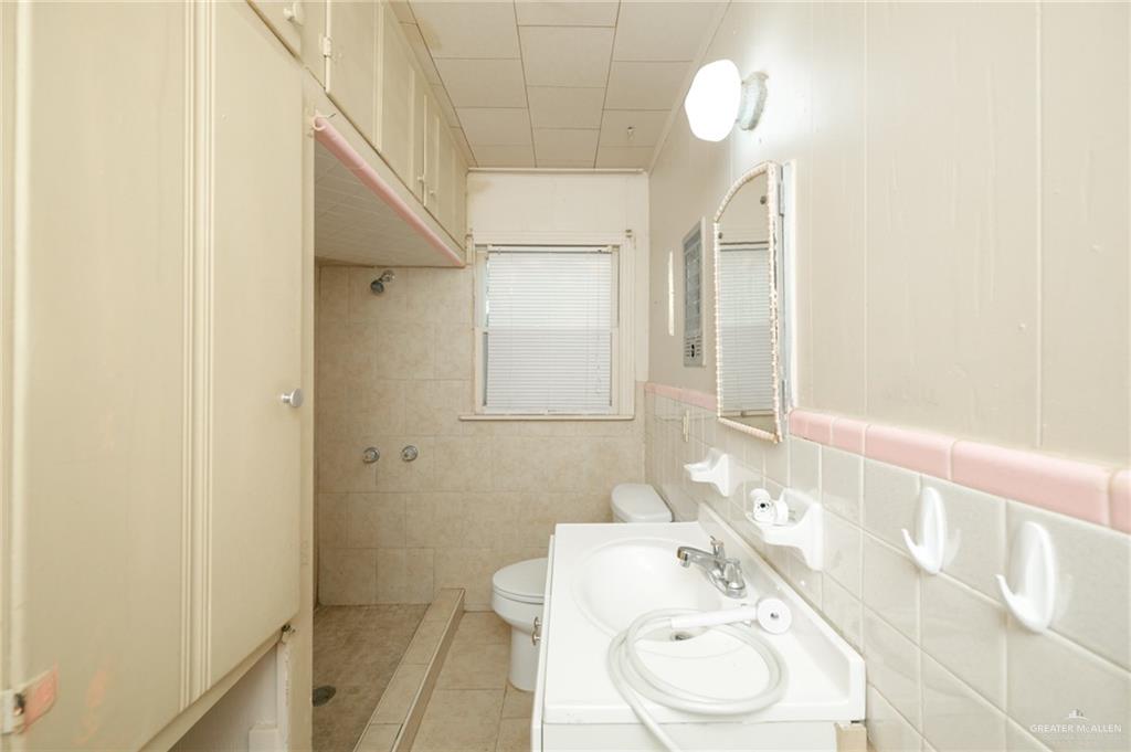 2125 Tucker Road Harlingen, TX 78552 - Photo 16 of 26 a bathroom with a toilet sink and mirror