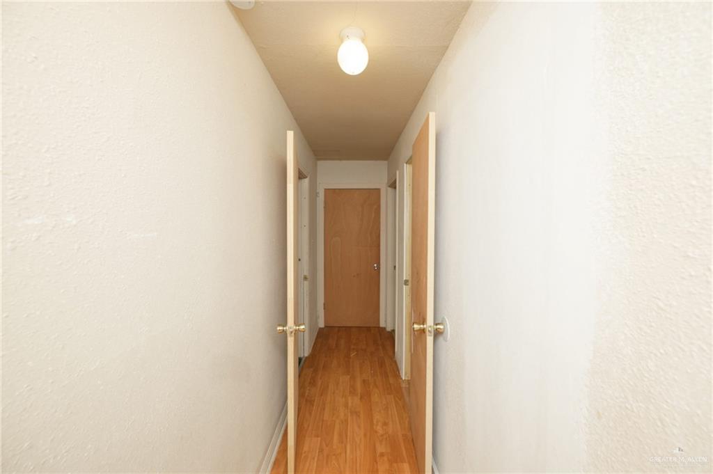 2125 Tucker Road Harlingen, TX 78552 - Photo 20 of 26 a view of a hallway with wooden floor