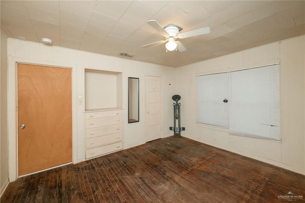 2125 Tucker Road Harlingen, TX 78552 - Photo 9 of 26 wooden floor in an empty room with a window
