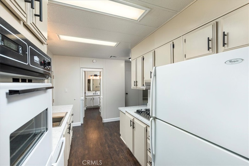 31130 South General Kearny Road, Unit 134 Temecula, CA 92591 - Photo 13 of 56 Looking from one end of the kitchen. New counters and stove top. Refrigerator included. Freshly painted.