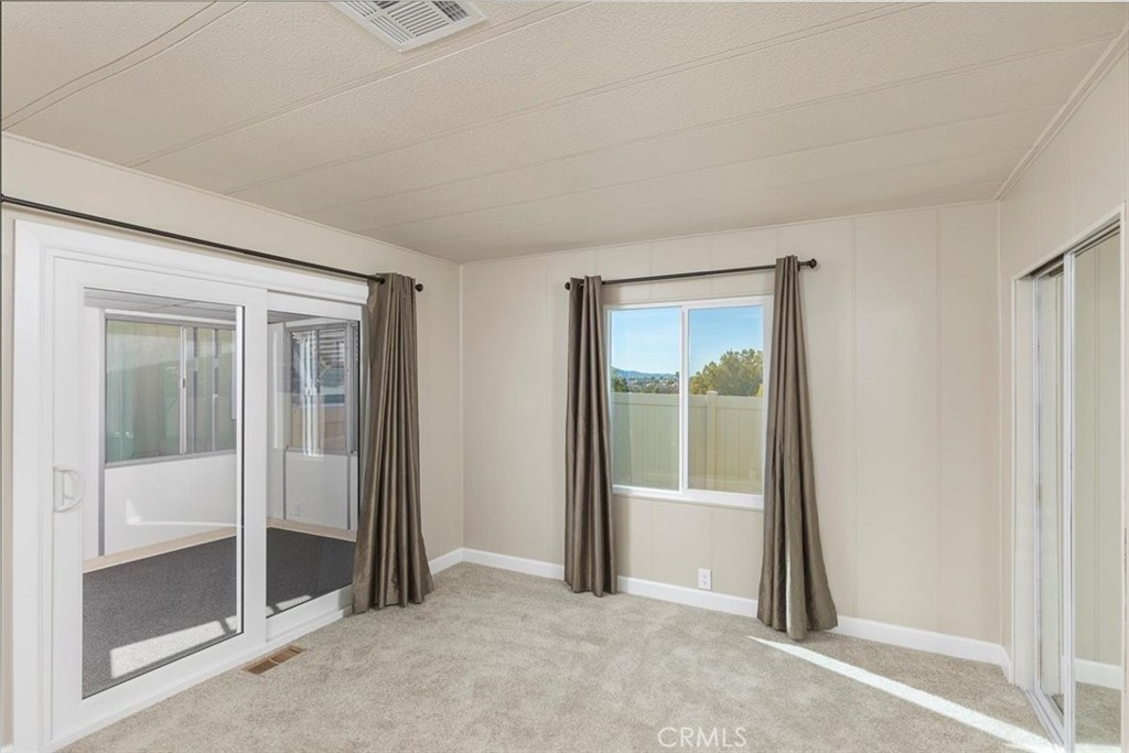 31130 South General Kearny Road, Unit 134 Temecula, CA 92591 - Photo 14 of 56 Primary suite new sliding door out to sunroom. New paint and carpet.