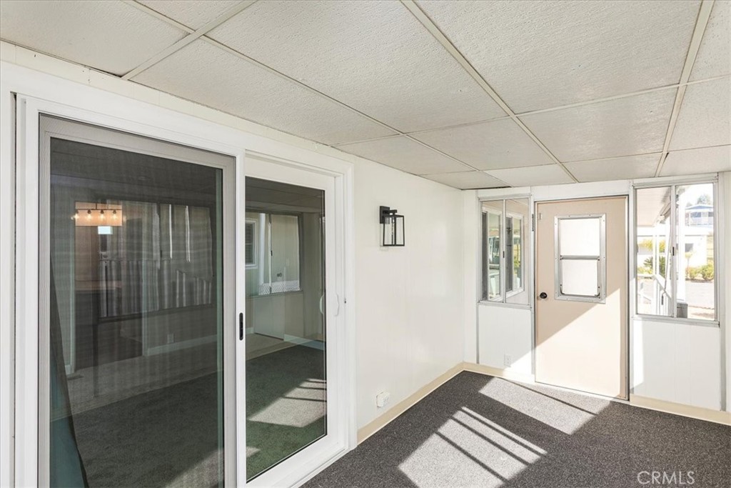 31130 South General Kearny Road, Unit 134 Temecula, CA 92591 - Photo 21 of 56 Enclosed sunroom with sliding door into primary suite and door out to front porch.