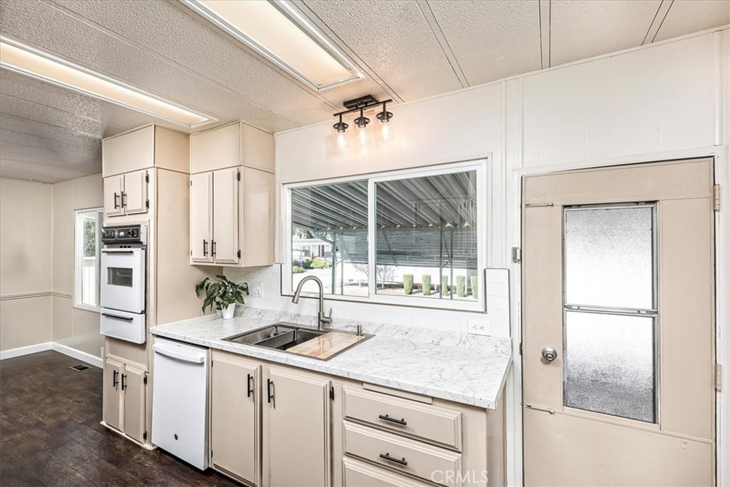 31130 South General Kearny Road, Unit 134 Temecula, CA 92591 - Photo 6 of 56 Kitchen with new window, light and counter tops. Door out to carport.