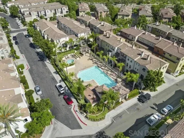 an aerial view of residential houses with outdoor space