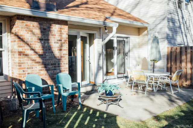 an outdoor space with lots of chairs and mirrors