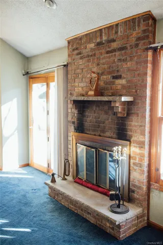 a living room with fireplace furniture and a window