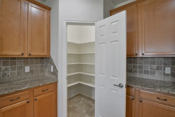 a kitchen with granite countertop a sink and cabinets