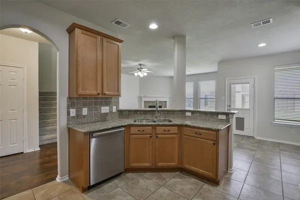 a kitchen with a sink stove and cabinets