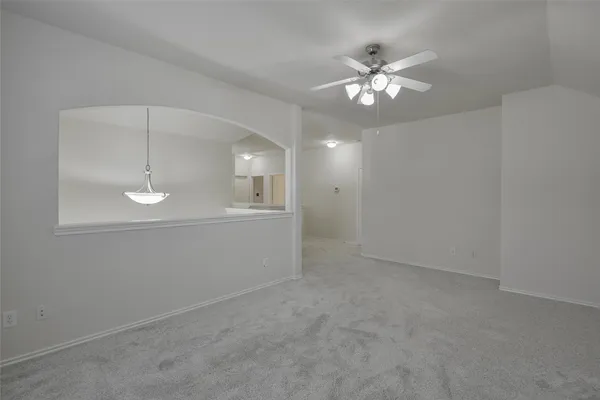 a view of a chandelier fan and entryway
