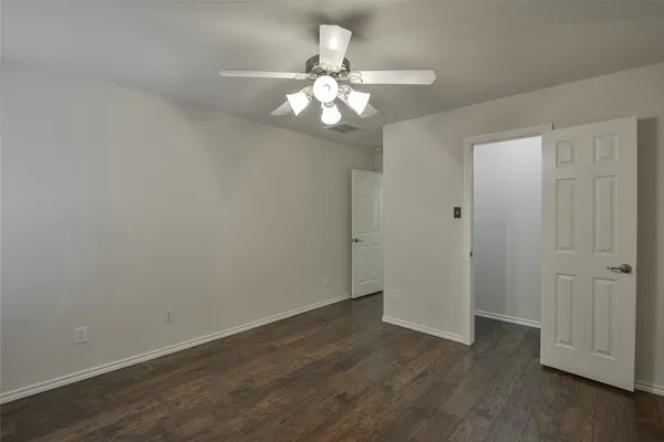 a view of a chandelier in big room and chandelier fan