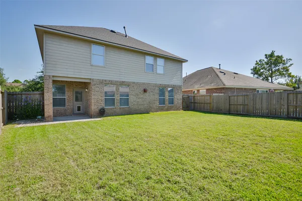 a view of a house with a backyard