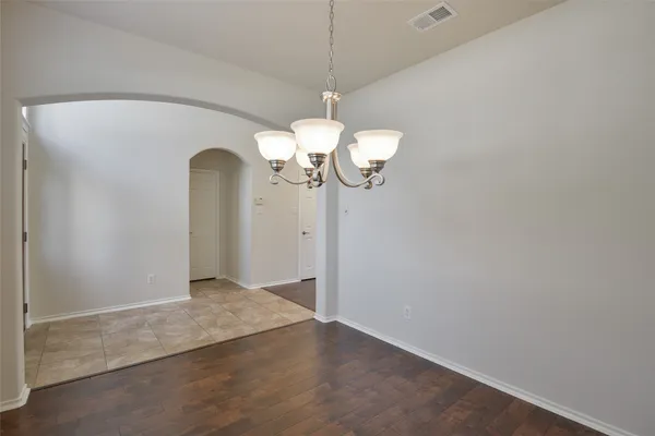 a view of a chandelier fan and wooden floor