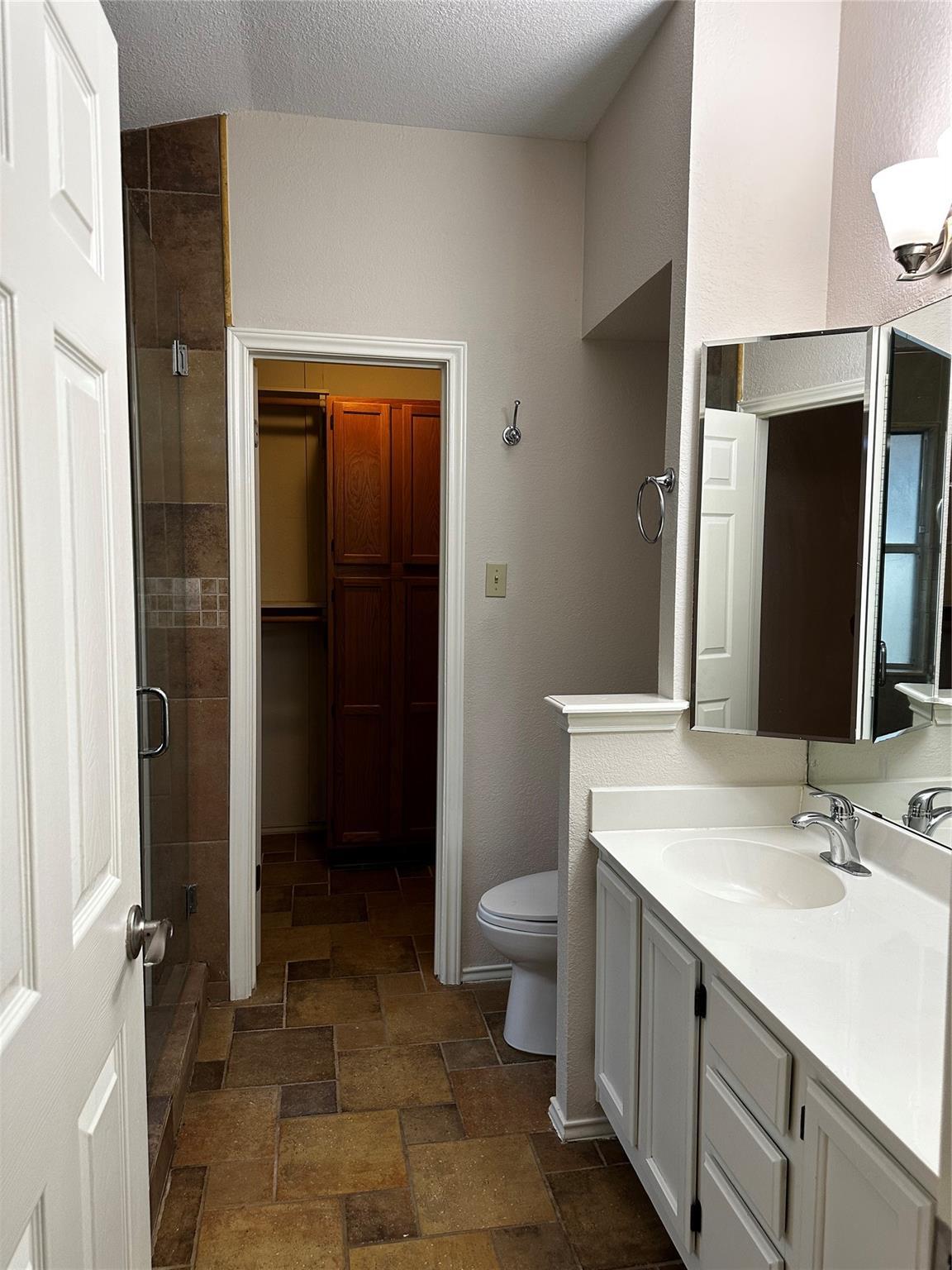 8007 Bounty Trail Austin, TX 78749 - Photo 20 of 32 Functional bathroom featuring a single vanity and a glass-enclosed shower with tile surround.